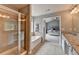 Spacious bathroom with soaking tub, glass shower, and granite countertops at 450 Hilingdon Way, Suwanee, GA 30024