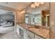 Bathroom featuring granite countertops, dual sinks, a soaking tub and glass-enclosed shower at 450 Hilingdon Way, Suwanee, GA 30024