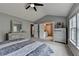 Bedroom with a ceiling fan, closet, and a view of an attached bathroom at 450 Hilingdon Way, Suwanee, GA 30024