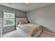Neutral bedroom with a large window letting in plenty of natural light at 450 Hilingdon Way, Suwanee, GA 30024