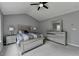 Bedroom with vaulted ceilings, a ceiling fan, and large windows providing ample light at 450 Hilingdon Way, Suwanee, GA 30024