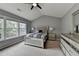 Bedroom with vaulted ceilings, a ceiling fan, and large windows providing ample light at 450 Hilingdon Way, Suwanee, GA 30024