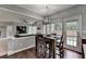 Bright dining area featuring hardwood floors and a modern chandelier fixture at 450 Hilingdon Way, Suwanee, GA 30024