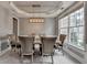 Dining room with modern light fixture, neutral paint, and large window at 450 Hilingdon Way, Suwanee, GA 30024