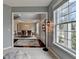 Foyer showing the front door, hardwood floors, and views into the dining room at 450 Hilingdon Way, Suwanee, GA 30024