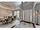 Foyer with view of the dining room featuring hardwood floors and natural light at 450 Hilingdon Way, Suwanee, GA 30024