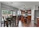 Gorgeous kitchen with stainless steel appliances, center island, and dining area at 450 Hilingdon Way, Suwanee, GA 30024