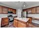 Kitchen featuring stainless appliances, stylish cabinets, and granite countertops at 450 Hilingdon Way, Suwanee, GA 30024