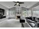 Bright living room featuring a fireplace, vaulted ceilings, and large windows at 450 Hilingdon Way, Suwanee, GA 30024