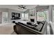 Living room with comfortable leather sofa, fireplace and view to the outside at 450 Hilingdon Way, Suwanee, GA 30024