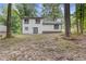 The backyard features the back of the home in a wooded setting at 4847 Royal Dr, Duluth, GA 30096