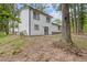 The backyard features the back of the home in a wooded setting at 4847 Royal Dr, Duluth, GA 30096