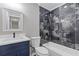 Bathroom featuring a shower with black tile surround, marble countertops, and modern fixtures at 4847 Royal Dr, Duluth, GA 30096