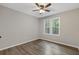 Bedroom features natural light, neutral walls, ceiling fan and wood floors at 4847 Royal Dr, Duluth, GA 30096