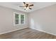 Bedroom features natural light, neutral walls, ceiling fan and wood floors at 4847 Royal Dr, Duluth, GA 30096