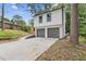 Exterior view of a two-story home with a spacious driveway leading to a two-car garage at 4847 Royal Dr, Duluth, GA 30096