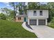 Charming two-story home with a front porch, freshly landscaped yard and a two-car garage at 4847 Royal Dr, Duluth, GA 30096