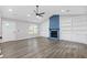 Living room featuring a blue painted stone fireplace, built-in shelving, and modern flooring at 4847 Royal Dr, Duluth, GA 30096