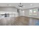 Spacious living room with modern flooring, open layout, and views of the kitchen at 4847 Royal Dr, Duluth, GA 30096