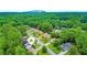 Expansive aerial view of neighborhood homes, surrounded by lush green trees and landscaping, with a mountain in the distance at 1012 Chapman Cir, Stone Mountain, GA 30088