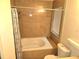 Tiled bathroom featuring a shower over tub and window at 1012 Chapman Cir, Stone Mountain, GA 30088