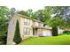 Inviting two-story home with attached garage, lush green lawn, and mature trees in a peaceful setting at 1012 Chapman Cir, Stone Mountain, GA 30088
