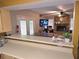 Open-concept living room featuring a stone fireplace, bar seating, and access to an outdoor deck at 1012 Chapman Cir, Stone Mountain, GA 30088