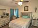 Cozy main bedroom with ceiling fan, dresser with mirror, and large bed at 1012 Chapman Cir, Stone Mountain, GA 30088