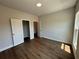 Spacious bedroom with hardwood floors and an open closet for optimal storage at 157 Basil St, Cumming, GA 30040