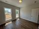 Bright bedroom featuring hardwood floors, neutral paint, large windows, and plenty of natural light at 157 Basil St, Cumming, GA 30040