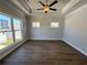 Sun-filled bedroom with hardwood flooring, large windows, and neutral paint, ready for new owners at 157 Basil St, Cumming, GA 30040