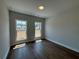 Bedroom with hardwood floors, two windows and views of the surrounding neighborhood at 157 Basil St, Cumming, GA 30040