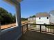 View from the home's outdoor deck, overlooking the yard, neighborhood, and a bright blue sky at 157 Basil St, Cumming, GA 30040
