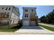 New construction home exterior featuring two car garage and a covered balcony at 157 Basil St, Cumming, GA 30040
