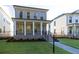 Charming brick home boasts a manicured lawn, covered front porch, and inviting curb appeal at 157 Basil St, Cumming, GA 30040