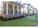 Beautifully landscaped front yard with lush green grass and a covered porch enhance the home's exterior at 157 Basil St, Cumming, GA 30040
