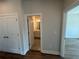 Hallway that leads to the ensuite bathroom, featuring a double sink, vanity, and great natural light at 157 Basil St, Cumming, GA 30040