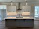 The gourmet kitchen boasts custom cabinets, a spacious island, and stylish fixtures for a luxurious feel at 157 Basil St, Cumming, GA 30040