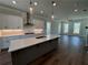 Modern kitchen features stainless steel appliances, a large center island, and sleek countertops at 157 Basil St, Cumming, GA 30040