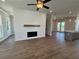 Open-concept living area with fireplace, hardwood floors, and seamless flow into the kitchen and dining space at 157 Basil St, Cumming, GA 30040