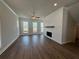 Comfortable living room showcases a modern fireplace feature, hardwood floors, and ample natural light at 157 Basil St, Cumming, GA 30040