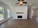 Bright and airy living room with a shiplap fireplace accent, hardwood floors, and ample natural light at 157 Basil St, Cumming, GA 30040