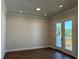 Bright living room with hardwood floors and glass doors leading to the outdoor deck and landscaping at 157 Basil St, Cumming, GA 30040