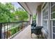 Balcony with iron railing, outdoor seating and a view of the surrounding greenery at 50 Biscayne Dr # 2106, Atlanta, GA 30309