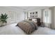 Spacious bedroom features neutral colors, plantation shutters, and access to a private balcony at 50 Biscayne Dr # 2106, Atlanta, GA 30309