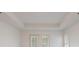 Bright bedroom featuring white walls, doors to the patio, and recessed ceiling details at 50 Biscayne Dr # 2106, Atlanta, GA 30309