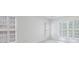 Bright bedroom featuring white walls and large windows with plantation shutters at 50 Biscayne Dr # 2106, Atlanta, GA 30309