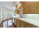 Bright kitchen with white countertops, wood cabinets, and a view into a bay windowed breakfast nook at 50 Biscayne Dr # 2106, Atlanta, GA 30309
