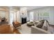 Bright living room features a fireplace, hardwood floors, and large windows with plantation shutters at 50 Biscayne Dr # 2106, Atlanta, GA 30309