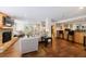 Inviting living room with a stacked stone fireplace, bar, and hardwood floors at 50 Biscayne Dr # 2106, Atlanta, GA 30309